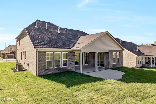 back of property featuring central AC, a yard, and a patio area