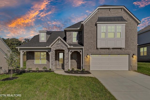 view of front of property featuring a garage and a yard