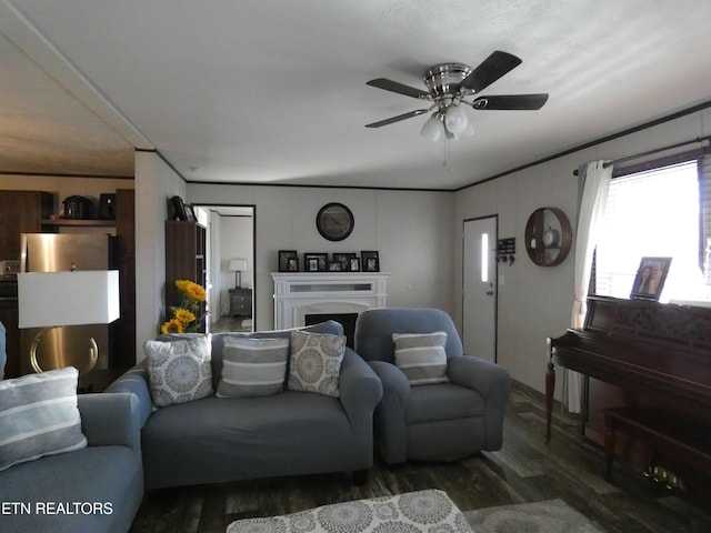 living room with crown molding, dark wood-type flooring, and ceiling fan