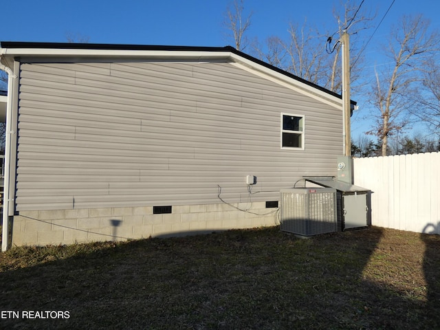 view of side of home with central air condition unit