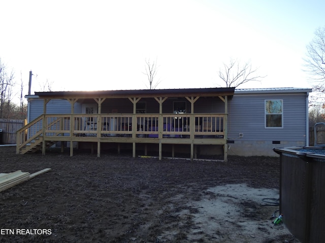 back of property featuring a wooden deck