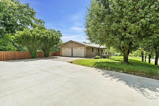 ranch-style home with a garage and a front yard