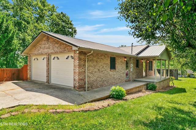 single story home with a garage, covered porch, and a front lawn