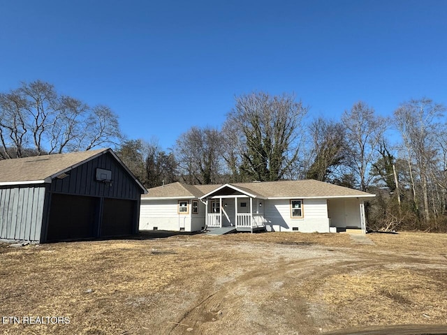 view of front of home with a porch, a garage, and an outdoor structure