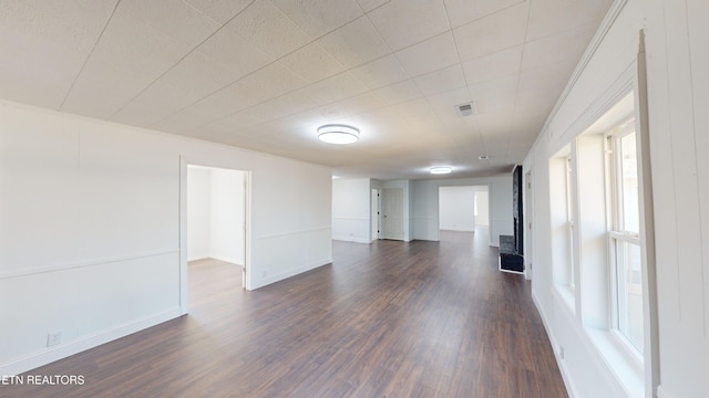 unfurnished room featuring dark hardwood / wood-style flooring