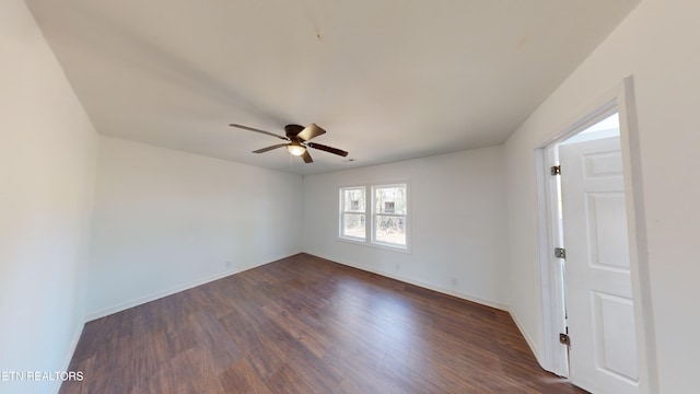 empty room featuring ceiling fan and dark hardwood / wood-style floors