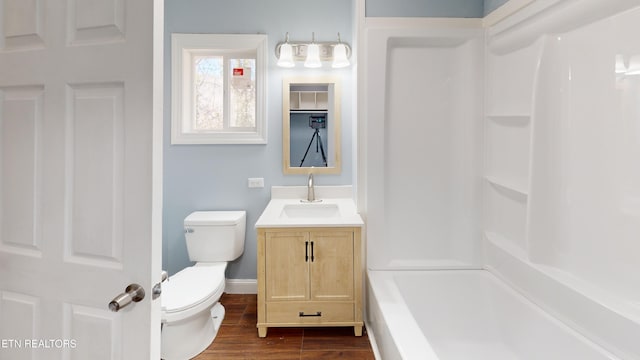 bathroom with hardwood / wood-style flooring, vanity, and toilet