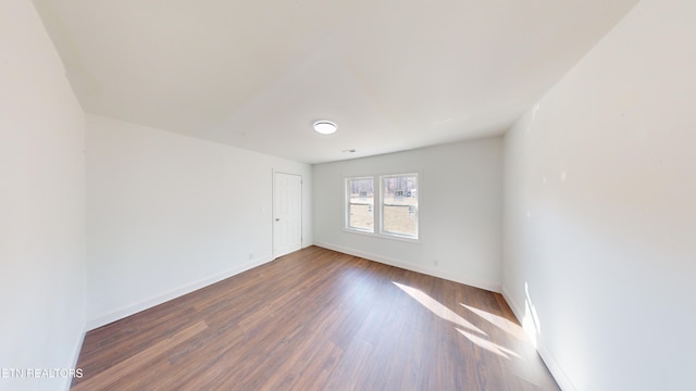 empty room featuring dark hardwood / wood-style flooring