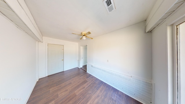 spare room featuring ceiling fan and dark hardwood / wood-style flooring