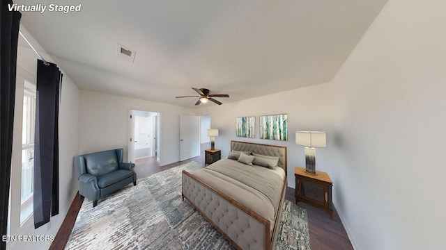 bedroom with multiple windows, hardwood / wood-style flooring, and ceiling fan