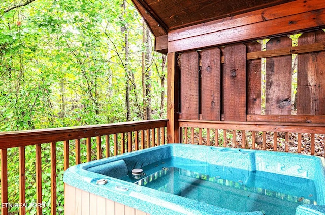 wooden deck with a hot tub