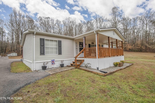 view of front of property with a porch and a front lawn