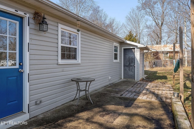 view of exterior entry featuring a patio area