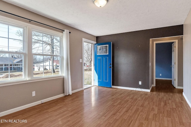 foyer entrance featuring hardwood / wood-style flooring and a textured ceiling