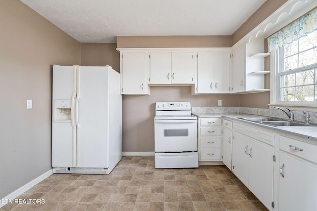 kitchen featuring white cabinetry, sink, a textured ceiling, and white appliances