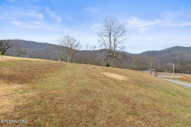 exterior space with a rural view and a mountain view