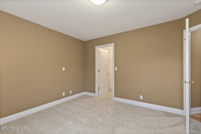 unfurnished bedroom featuring light colored carpet