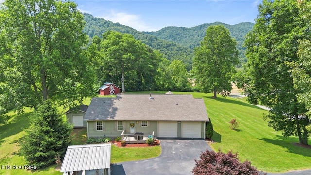 142 Wagon Wheel Ln, Pioneer, TN 37847 - view of front facade with a mountain view, a front lawn, driveway, and a garage