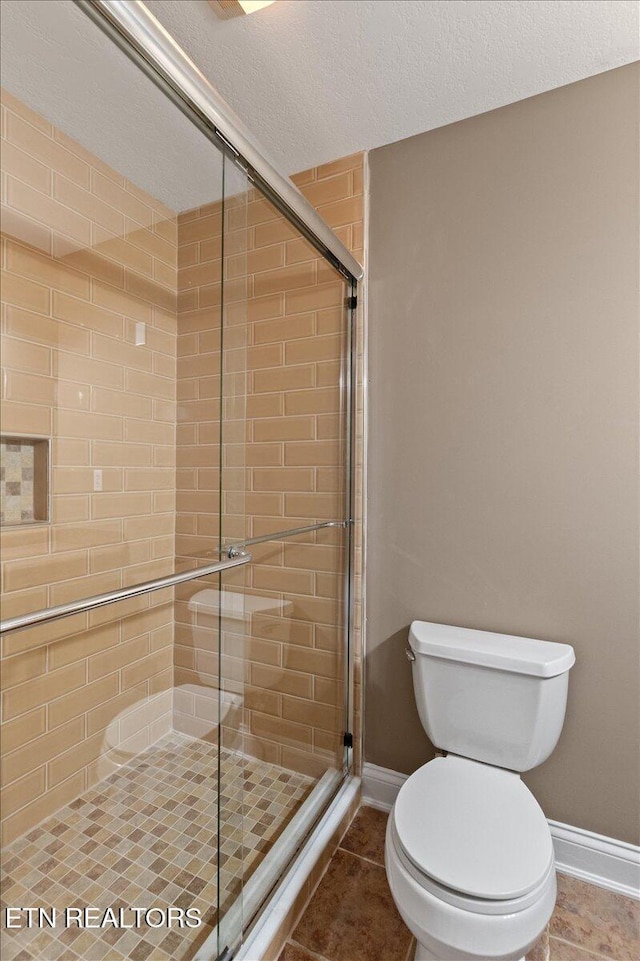 142 Wagon Wheel Ln, Pioneer, TN 37847 - bathroom with a stall shower, a textured ceiling, and tile patterned floors