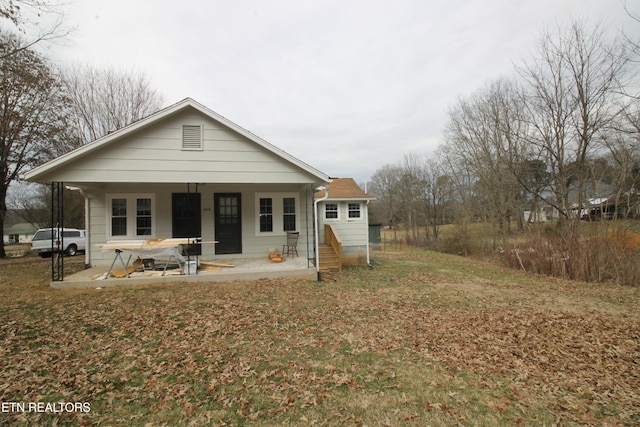 rear view of house featuring a porch