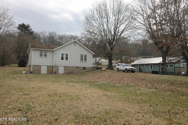 view of property exterior with a yard