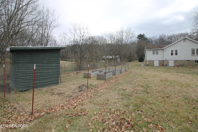 view of yard with a vegetable garden and fence