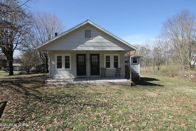 back of house with a lawn