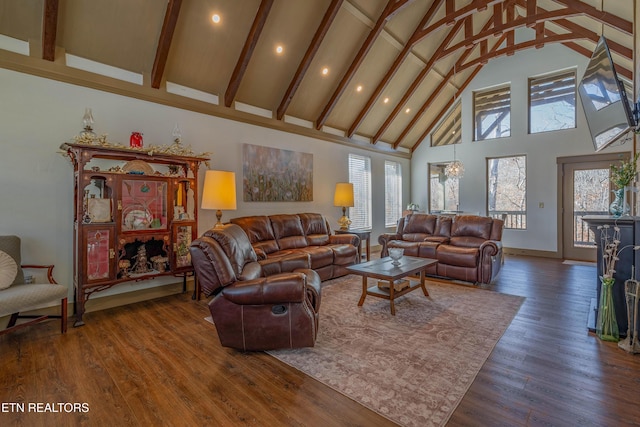 living room with beamed ceiling, dark hardwood / wood-style floors, and high vaulted ceiling