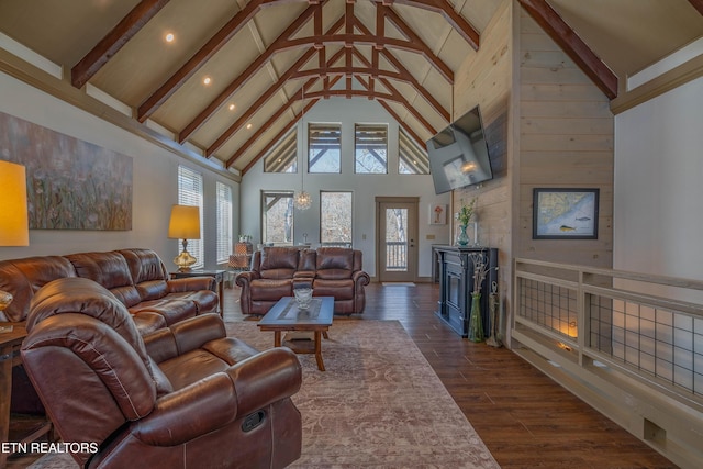 living room featuring beamed ceiling, dark wood-type flooring, and high vaulted ceiling