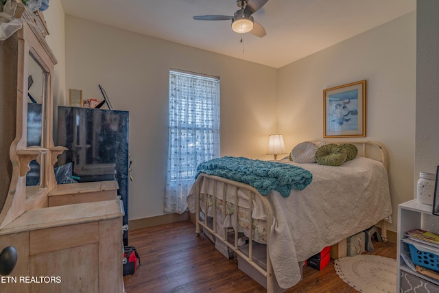 bedroom featuring ceiling fan and dark hardwood / wood-style floors