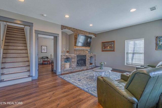 living room featuring dark hardwood / wood-style flooring and a fireplace