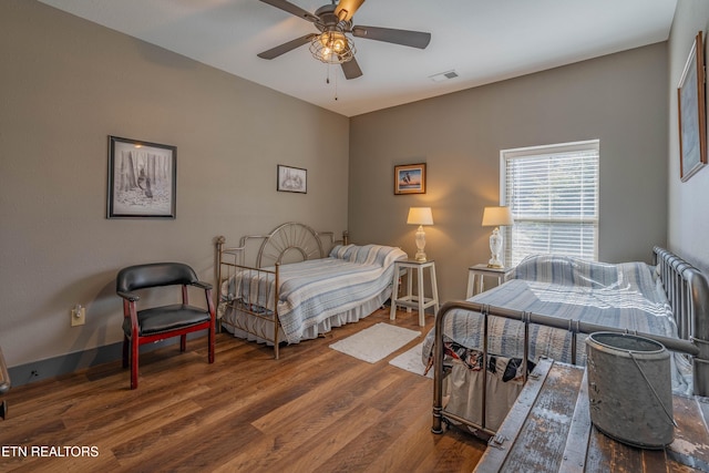 bedroom with hardwood / wood-style floors and ceiling fan