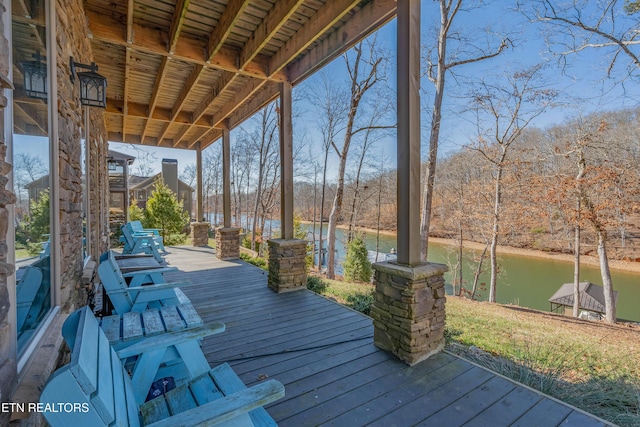 wooden deck featuring a water view