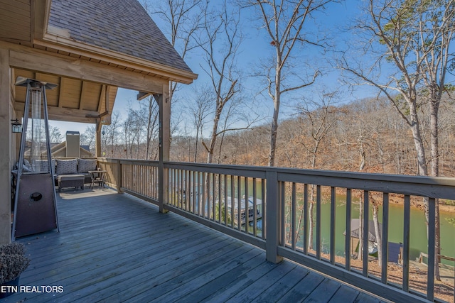 wooden terrace featuring a water view