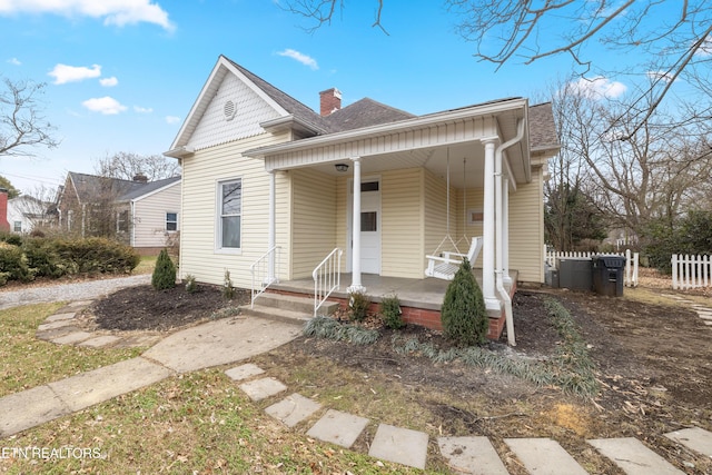 112 E Inskip Dr, Knoxville, TN 37912 - view of front of property with a porch, a shingled roof, a chimney, and fence