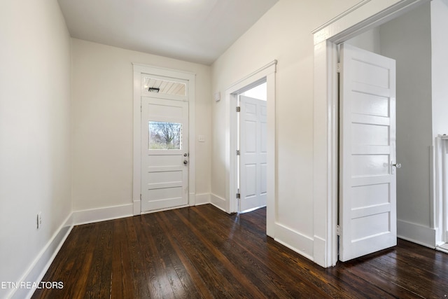 entryway with baseboards and dark wood-type flooring