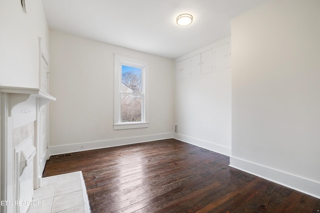 112 E Inskip Dr, Knoxville, TN 37912 - unfurnished living room featuring dark wood-style flooring and baseboards