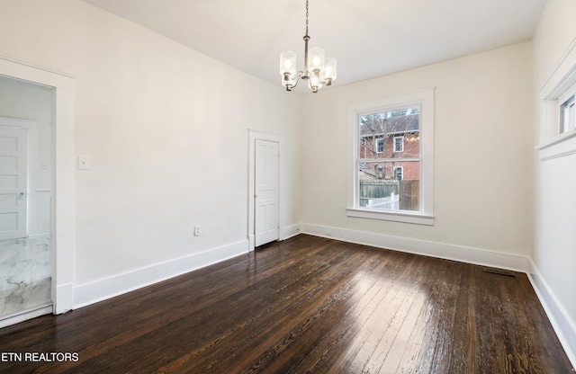 112 E Inskip Dr, Knoxville, TN 37912 - unfurnished dining area with a chandelier, dark wood-type flooring, and baseboards