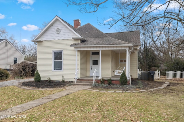 112 E Inskip Dr, Knoxville, TN 37912 - view of front of home featuring a chimney, a shingled roof, a porch, and crawl space