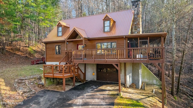 view of front facade featuring a deck and a sunroom