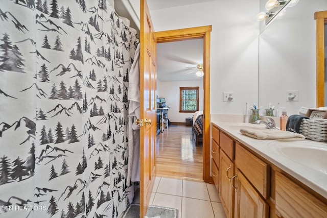 bathroom featuring ceiling fan, tile patterned floors, a shower with shower curtain, and vanity