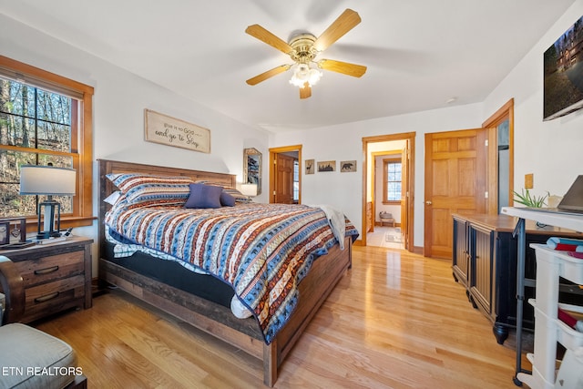 bedroom with light hardwood / wood-style flooring and ceiling fan