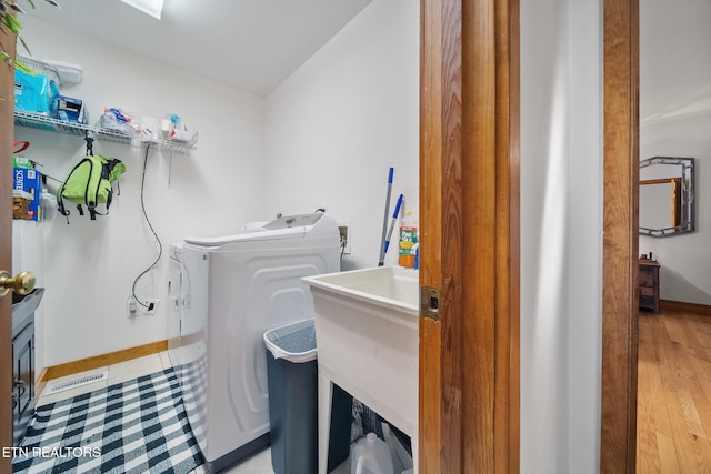 clothes washing area featuring independent washer and dryer