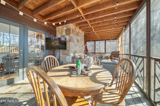 sunroom featuring lofted ceiling with beams, wood ceiling, and french doors