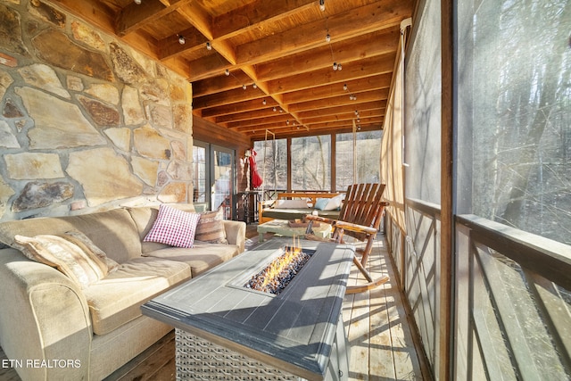 sunroom featuring wood ceiling, french doors, and beamed ceiling