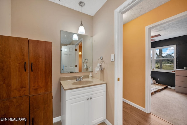 bathroom featuring vanity, hardwood / wood-style floors, and a textured ceiling