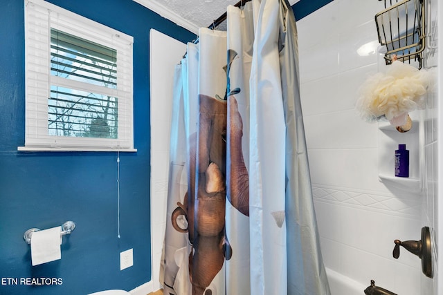 bathroom with ornamental molding, toilet, shower / tub combo, and a textured ceiling