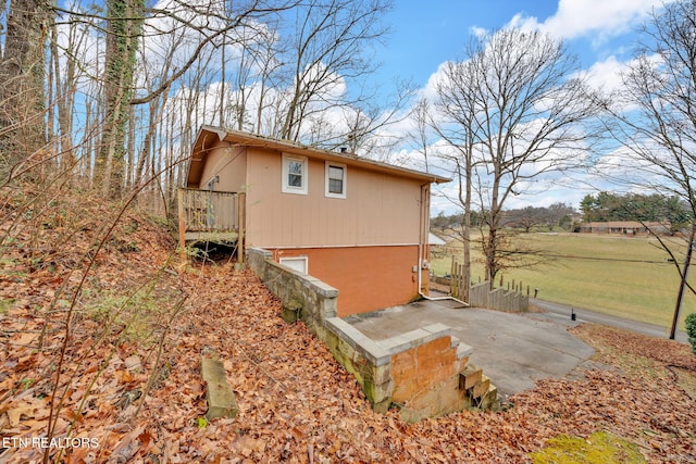 view of side of property featuring a patio area