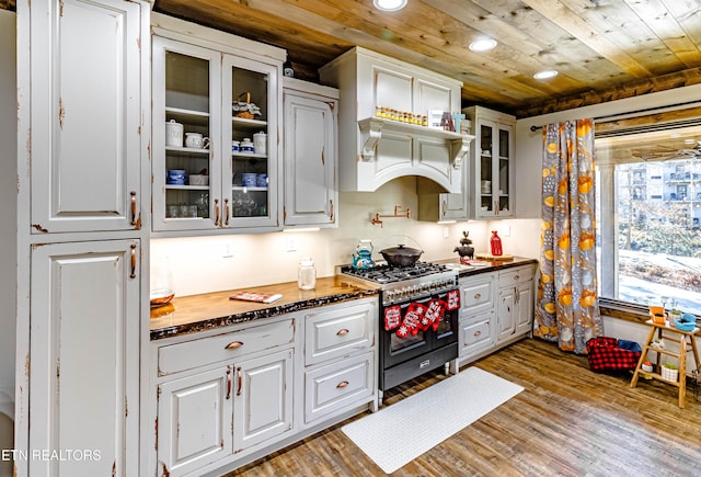 kitchen with white cabinetry, double oven range, wood ceiling, and dark hardwood / wood-style floors