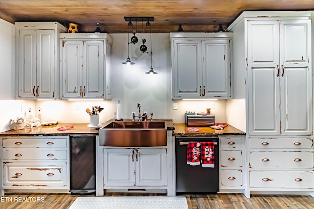 kitchen featuring decorative light fixtures, white cabinetry, sink, wood ceiling, and light hardwood / wood-style floors